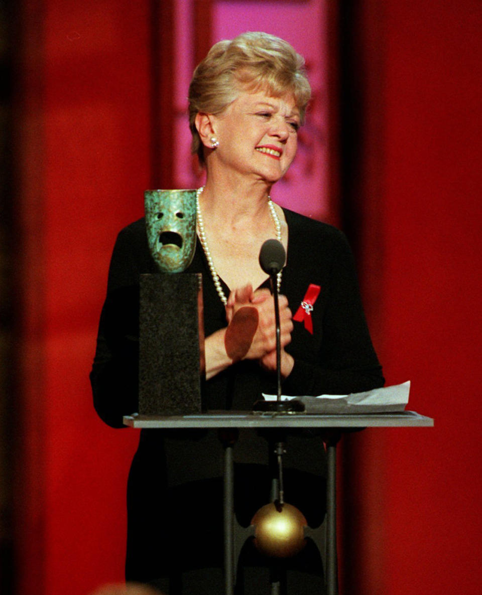 FILE - Actress Angela Lansbury reacts to the standing ovation by her peers after she was honored with a lifetime achievement award during the 3rd annual Screen Actors Guild Awards in Los Angeles on Feb. 22, 1997. Lansbury, the big-eyed, scene-stealing British actress who kicked up her heels in the Broadway musicals “Mame” and “Gypsy” and solved endless murders as crime novelist Jessica Fletcher in the long-running TV series “Murder, She Wrote,” died peacefully at her home in Los Angeles on Tuesday. She was 96. (AP Photo/Kevork Djansezian, File)