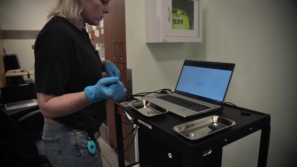 Amanda Gunn, CTS team lead, uses a drug testing machine. The centre has noted that drugs are more often adulterated with other substances, such as fentanyl mixed with benzodiazepines or even stronger opioids with the street name "pyro."