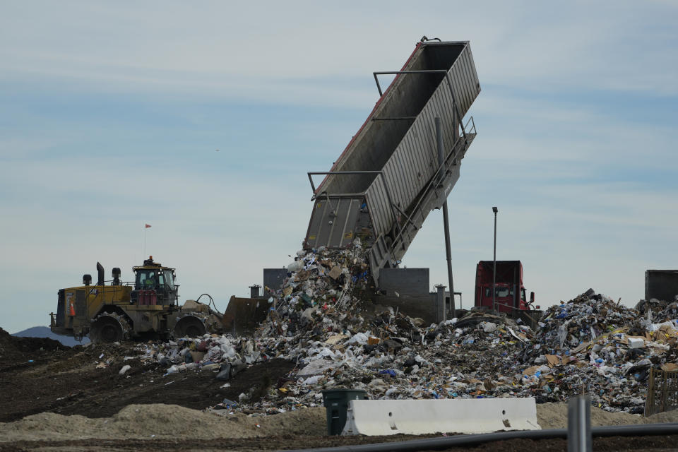 Trash is unloaded at the Otay Landfill in Chula Vista, Calif., on Friday, Jan. 26, 2024. Two years after California launched an effort to keep organic waste out of landfills, the state is so far behind on getting food recycling programs up and running that it's widely accepted next year's ambitious waste-reduction targets won't be met. Over time, food scraps and other organic materials like yard waste emit methane, a gas more potent and damaging in the short-term than carbon emissions from fossil fuels. (AP Photo/Damian Dovarganes)