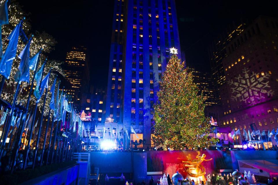 FILE - This Nov. 28, 2012 file photo shows the 80-foot-tall Rockefeller Center Christmas during the 80th annual lighting ceremony in New York. This year's Rockefeller Center tree will be lit on Dec. 3, 2013, and for the seventh year in a row, it will be donated to Habitat for Humanity, to be milled into lumber for use in building a home. (Photo by Charles Sykes/Invision/AP, File)