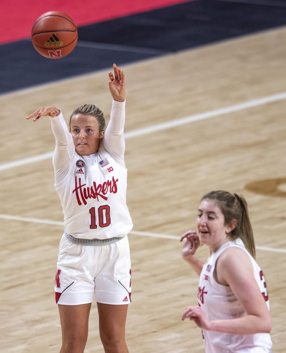 Nebraska's Whitney Brown (10) shoots for her second three-point basket against Northwestern in the first half as teammate Kate Cain (31) looks on during an NCAA college basketball game Thursday, Dec. 31, 2020, in Lincoln, Neb. (Francis Gardler/Lincoln Journal Star via AP)