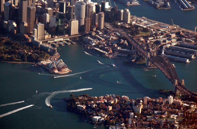 FILE PHOTO: The Sydney Harbour Bridge casts a shadow next to the Sydney Opera House and CBD as boats make their along the harbour