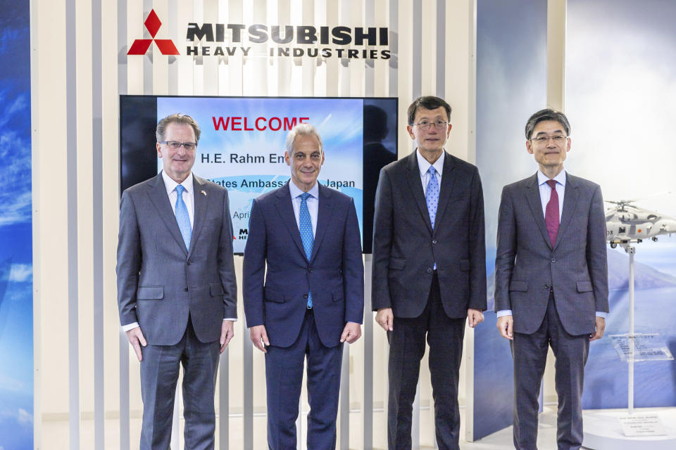 In this photo provided by U.S. Embassy in Japan, U.S. Ambassador to Japan, Rahm Emanuel, center left, poses with the officials of Mitsubishi Heavy Industries (MHI) and Lockheed, during his visit to a MHI’s F-35 fighter jet final assembly and inspection plant in the town of Toyoyama in the Aichi prefecture, western Japan, Tuesday, April 16, 2024. (U.S. Embassy via AP)
