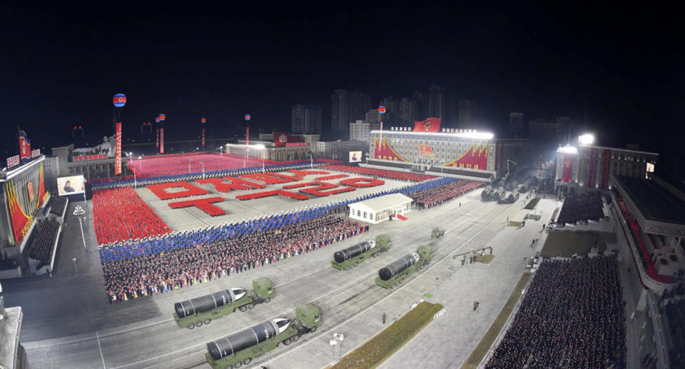 rows of marching soldiers, as well as a range of military hardware including tanks and rocket launchers