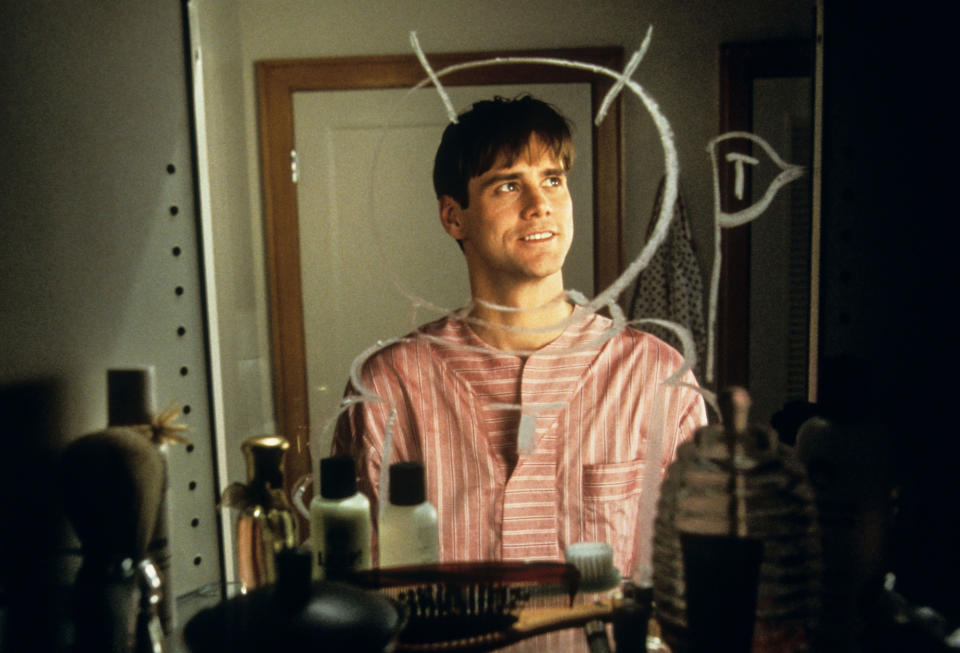 Jim Carrey looking in a mirror, with a circle drawn over his face in the mirror