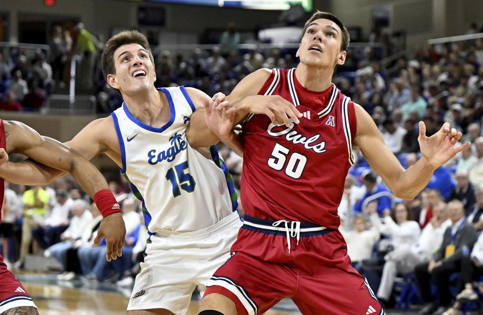 Florida Atlantic's Vladislav Goldin (50) fights for rebounding position against Florida Gulf Coast's Blaise Vespe (15) in the first half of an NCAA college basketball game, Saturday, Dec. 30, 2023, in Fort Myers, Fla. (AP Photo/Chris Tilley)