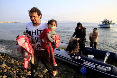 A Syrian refugee family arrives on a dinghy at a beach on the Greek island of Kos, August 11, 2015. REUTERS/Yannis Behrakis