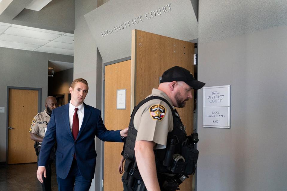 Austin police officer Christopher Taylor, in the blue suit. exits the courtroom Wednesday after his murder trial in the 2020 shooting of Michael Ramos ended in a mistrial. The judge declared a mistrial after the jurors said they could not come to a unanimous decision after more than 34 hours of deliberation.