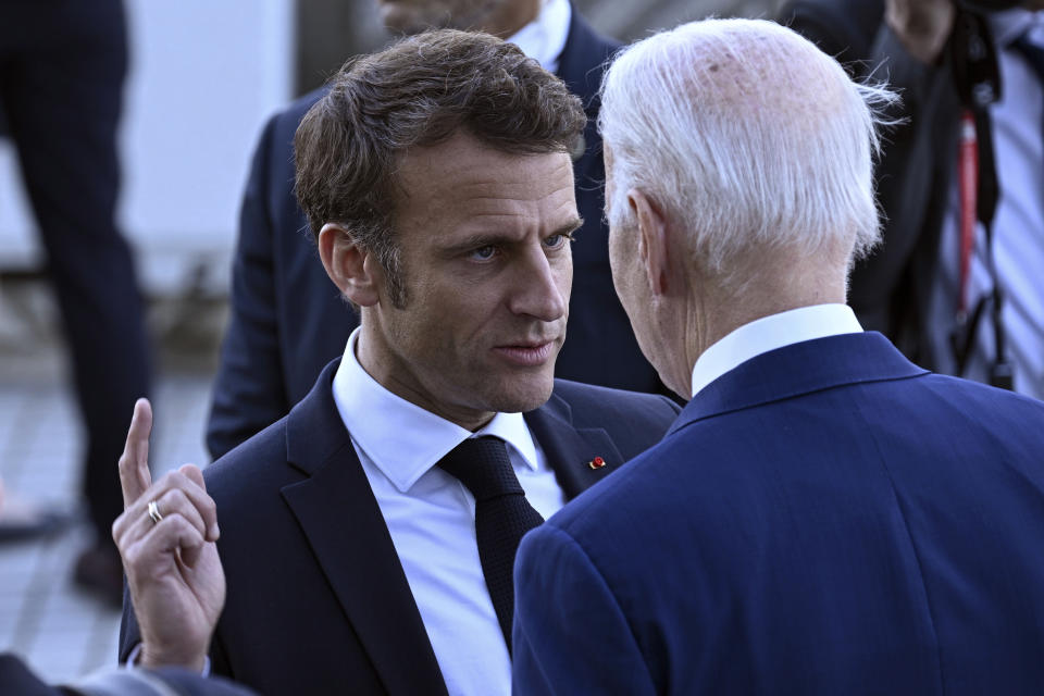 France's President Emmanuel Macron, left, speaks with U.S. President Joe Biden before a family photo of leaders of the G7 and invited countries during the G7 Leaders' Summit in Hiroshima, western Japan, Saturday, May 20, 2023. (Brendan Smialowski/Pool Photo via AP)