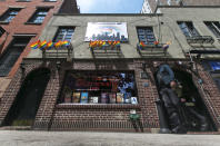 FILE - In this May 29, 2014 file photo, a man passes The Stonewall Inn in New York's Greenwich Village. The bar was the site of the Stonewall uprising that started on June 28, 1969 and galvanized the Gay Rights Movement. June 2019 Pride Month marks the 50th Anniversary of the Stonewall uprising, with events that commemorate that moment and its impact through the last five decades. (AP Photo/Richard Drew, File)