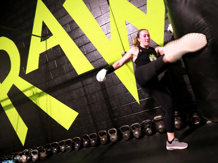 Heather Dunham with a big kick during at workout at RAW Bodies Under Construction gym in the former Taunton Gazette building on Wednesday, April 6, 2022.