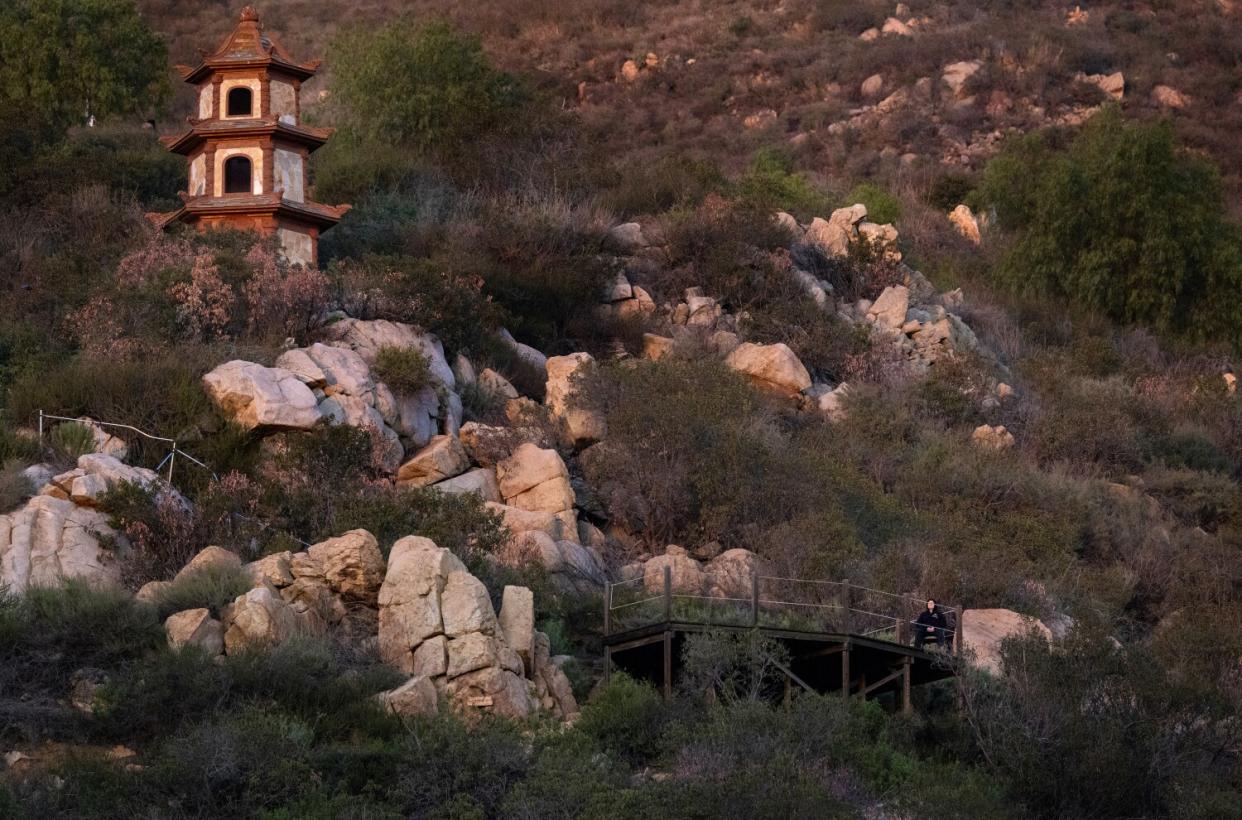 A visitor sits alone at Deer Park Monastery