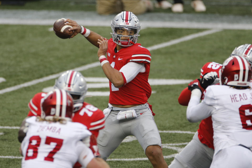 FILE - In this Nov. 21, 2020, file photo, Ohio State quarterback Justin Fields throws a pass against Indiana during the first half of an NCAA college football game in Columbus, Ohio. Fields repeated as offensive player of the year and is joined by three of his teammates on the Associated Press All-Big Ten football team. (AP Photo/Jay LaPrete, File)