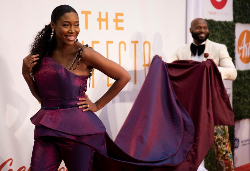 Justin Bridgeman holds cape of sister, Louisville businesswoman Eden Bridgeman, on the red carpet at Trifecta Gala 2019, a Kentucky Derby Eve party in Louisville. May 3, 2019.