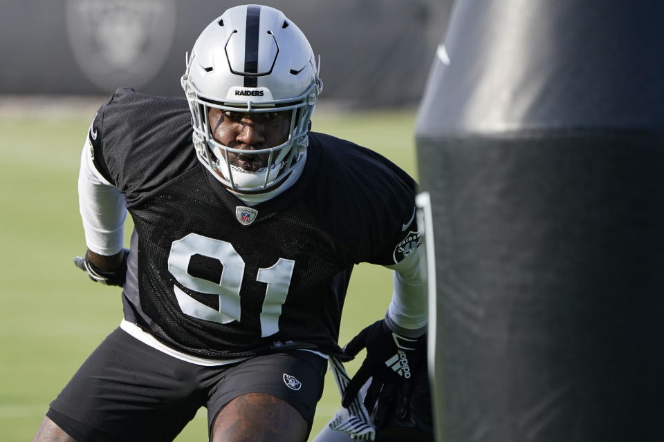 FILE - In this uesday, June 15, 2021 file photo, Las Vegas Raiders defensive end Yannick Ngakoue takes part in a drill during an NFL football practice in Henderson, Nev. The Raiders bolstered the pass rush with the addition of edge rusher Yannick Ngakoue and defensive tackle Quinton Jefferson and added help in the secondary in veteran cornerback Casey Hayward and rookie safety Tre'von Moehrig.(AP Photo/John Locher, File)