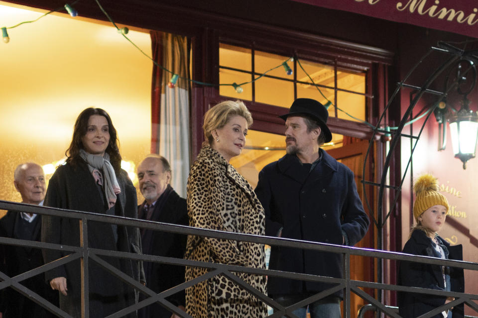 This image released by IFC Films shows, foreground from left, Juliette Binoche, Catherine Deneuve, Ethan Hawke and Clémentine Grenier in a scene from "The Truth." (IFC Films via AP)