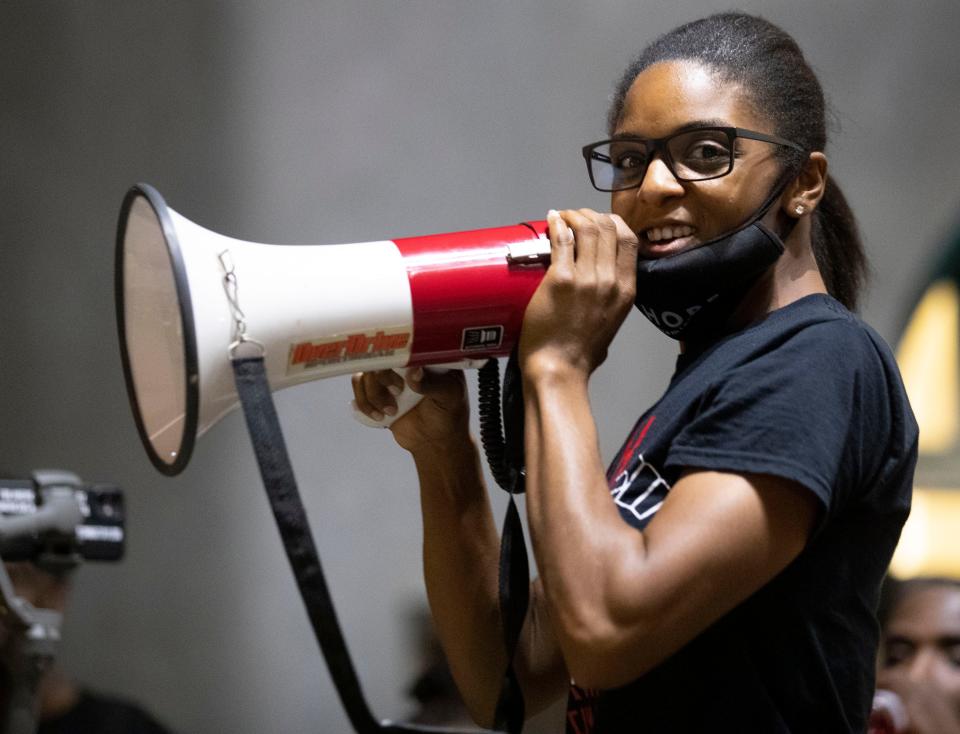 Stachelle Bussey speaks to the crowd inside the courtyard at First Unitarian Church on Friday, Sept. 25, 2020, in downtown Louisville.