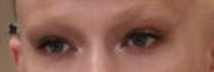 A close-up of one of the sister's eyes, with eyebrows bleached to the point they're hard to see