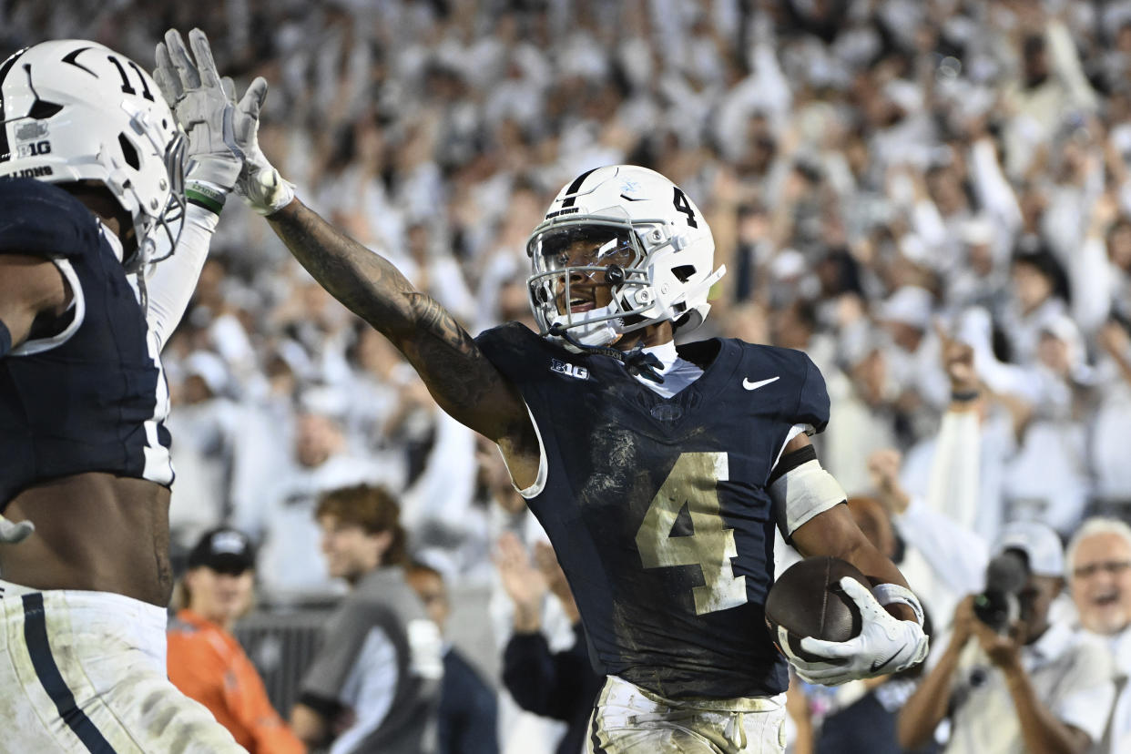 Penn State cornerback A.J. Harris (4) celebrates after an interception with Abdul Carter (11) during the fourth quarter of an NCAA college football game against Illinois, Saturday, Sept. 28, 2024, in State College, Pa. (AP Photo/Barry Reeger)