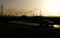 The sun sets behind Isla refinery in Willemstad at the island of Curacao June 16, 2008. REUTERS/Jorge Silva/File Photo