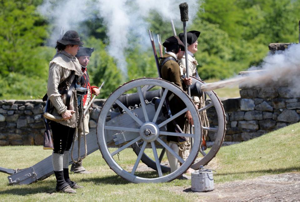 In this Friday, June 17, 2016, photo, historical interpreters fire a cannon during an afternoon demonstration at Fort Ticonderoga in Ticonderoga, New York. Fort Ticonderoga has educated and entertained visitors for decades with exhibits, fife-and-drum performances and cannon and musket demonstrations. Now the historic site overlooking Lake Champlain in New York's eastern Adirondack Mountains has two more attractions: a trail along America's bloodiest pre-Civil War battleground and cruises on a boat called the Carillon.