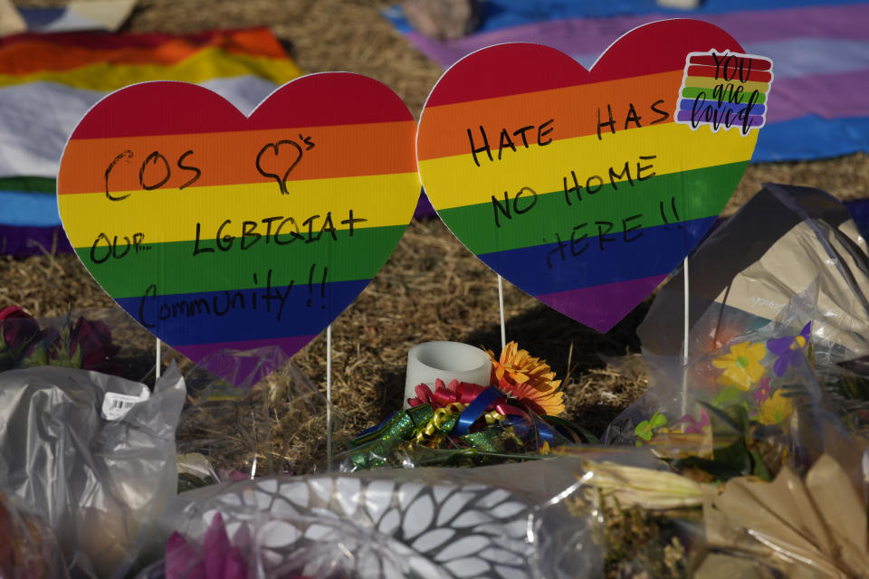 Heart-shaped signs bear messages of support in a makeshift memorial to the victims of a weekend mass shooting at a nearby gay nightclub on Tuesday, Nov. 22, 2022, in Colorado Springs, Colo. Anderson Lee Aldrich opened fire at Club Q, in which five people were killed and others suffered gunshot wounds before patrons tackled and beat the suspect into submission. (AP Photo/David Zalubowski)