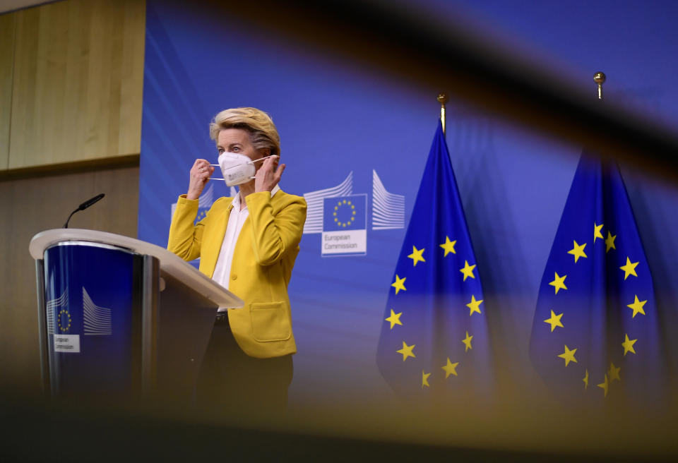 European Commission President Ursula von der Leyen puts on her protective face mask after delivering a statement at EU headquarters in Brussels, Wednesday, April 14, 2021. EU Commission chief Ursula von der Leyen announced plans Wednesday for a major contract extension for COVID-19 vaccines with Pfizer stretching to 2023. (John Thys, Pool via AP)