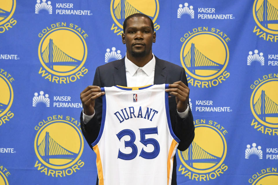 Jul 7, 2016; Oakland, CA, USA; Kevin Durant poses for a photo with his jersey during a press conference after signing with the Golden State Warriors at the Warriors Practice Facility. Mandatory Credit: Kyle Terada-USA TODAY Sports