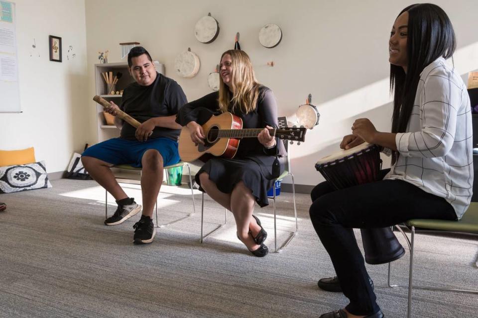 HopeWay clients play songs with music therapist Joan Kleinmann, center, as part of their integrative therapy.