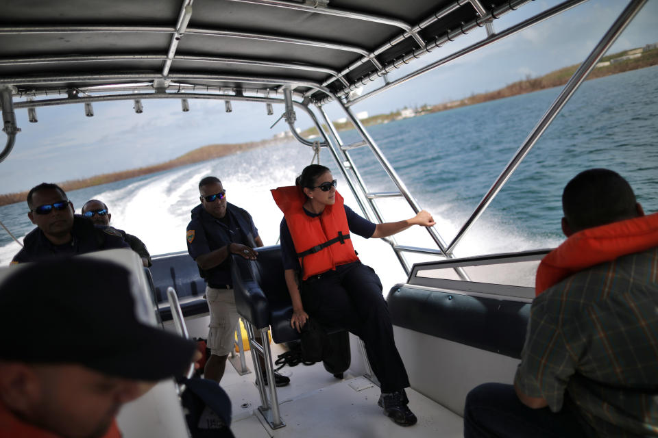 <p>U.S. Postal Service Police officers ride in a boat to deliver mail at Vieques island, weeks after Hurricane Maria hit Puerto Rico, in Vieques, Puerto Rico, Oct. 7, 2017. (Photo: Carlos Barria/Reuters) </p>