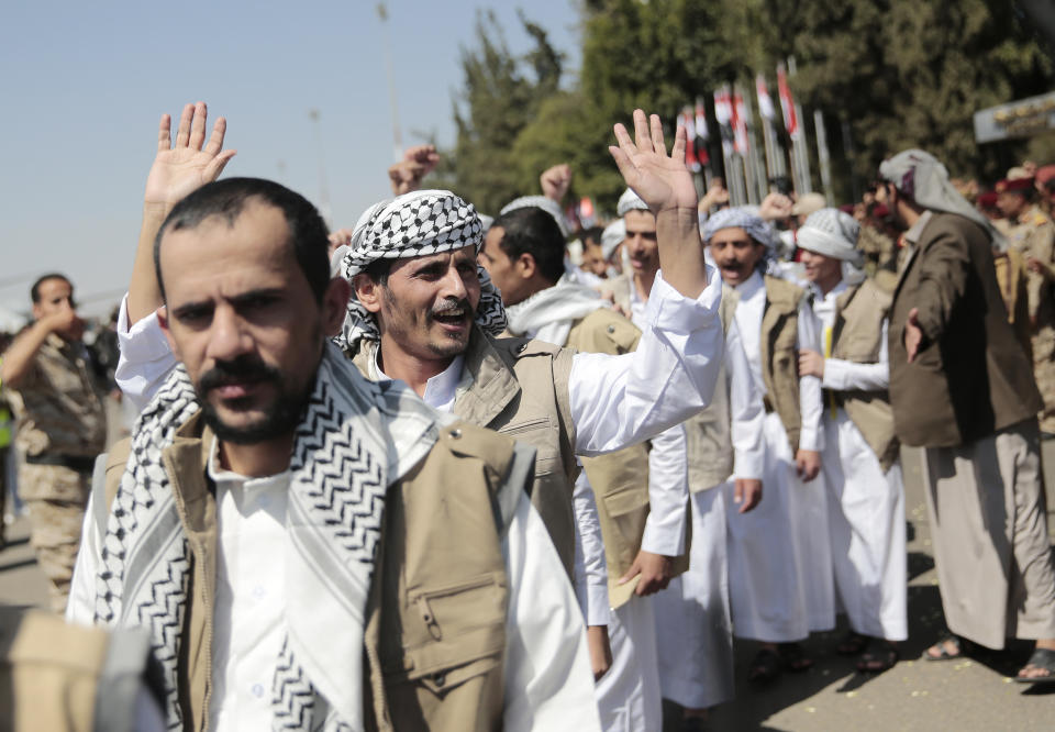 Yemeni prisoners chant slogans during their arrival after being released by the Saudi-led coalition at the airport in Sanaa, Yemen, Thursday, Oct. 15, 2020. (AP Photo/Hani Mohammed)