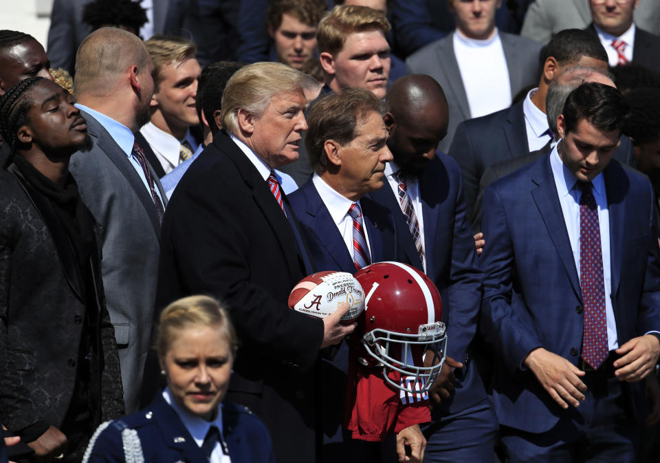 Here’s what we know: President Donald Trump signed a football when the Alabama football team visited the White House. (AP Photo)