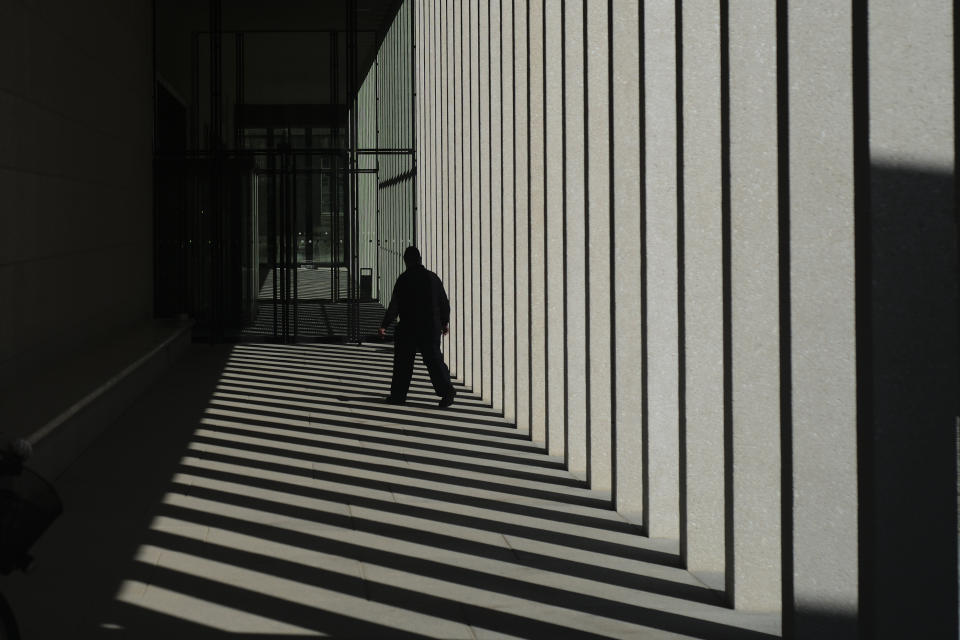 A man walks to an entrance of the James-Simon-Galerie in Berlin, Germany, Wednesday, July 10, 2019. The James-Simon-Galerie is the new central entrance building for Berlin's historic Museums Island and will officially open on Friday, Jul 12, 2019. (AP Photo/Markus Schreiber)