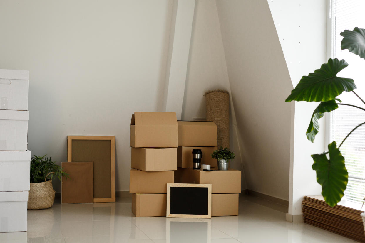  An empty living space with boxes stacked in preparation for moving. 