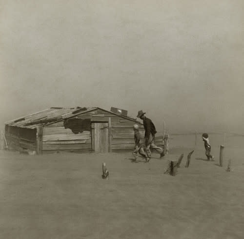 1280px-Farmer walking in dust storm Cimarron County Oklahoma2