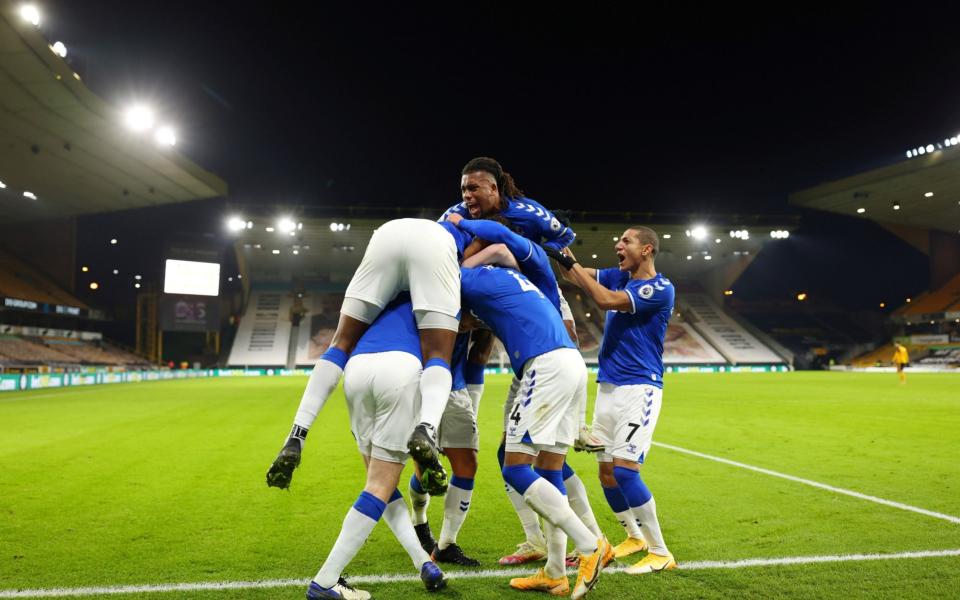 Everton's Michael Keane celebrates scoring their second goal with Alex Iwobi and teammates - Reuters