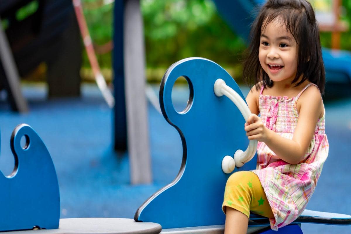 A stock image of a girl enjoying herself in a play area. Credit: Provided by Reading Borough Council