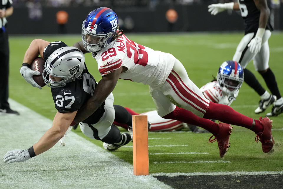 New York Giants safety Xavier McKinney (29) tackles Las Vegas Raiders cornerback Tyler Hall (37) just short of the goal line during the first half of an NFL football game, Sunday, Nov. 5, 2023, in Las Vegas. (AP Photo/John Locher)