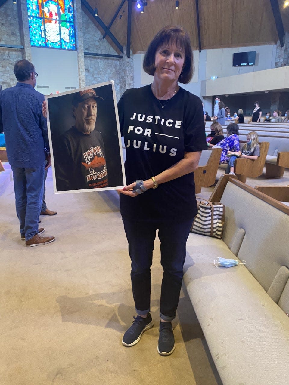 Nancy Vollertsen holds up a picture of her brother Greg Wilhoit before a Witness to Innocence presentation at Oklahoma City First Church of the Nazarene.