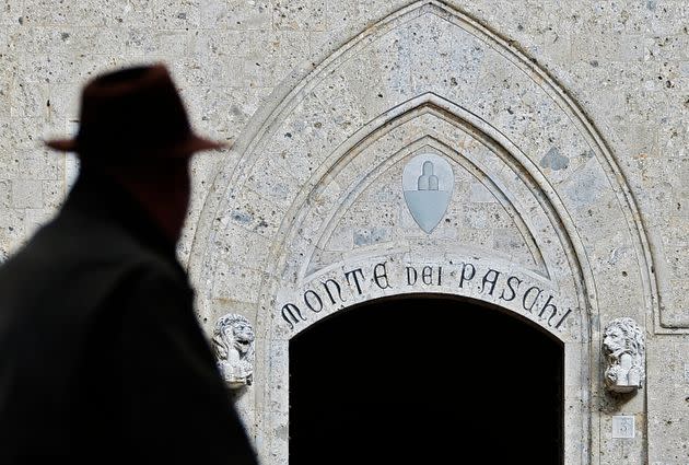 A man walks on January 25, 2013 past the headquarters of the Banca Monte dei Paschi di Siena (MPS), the world's oldest bank to adopt a government aid plan amid revelations of a derivatives scandal. A media report on January 22 that said BMPS would book a 220 million euro ($293 million) loss on a three-year-old derivative contract was a heavy blow for the floundering bank, which is concluding a deal with the government for 3.9 billion euros in state aid.      AFP PHOTO / FABIO MUZZI (Photo by FABIO MUZZI / AFP)        (Photo credit should read FABIO MUZZI/AFP via Getty Images) (Photo: AFP via Getty Images)