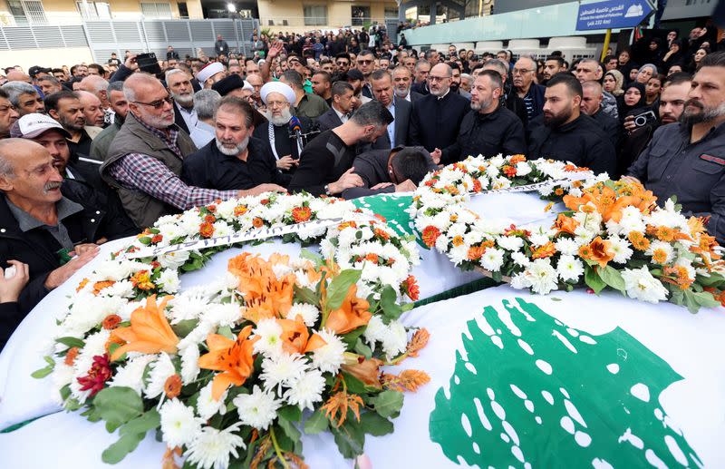 Mourners stand near the coffins of the two journalists working for Lebanon-based Al Mayadeen TV channel, in Beirut