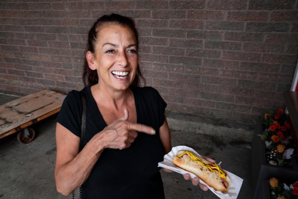 Joell Ehret, 57, of Madison Heights, an original New Yorker, says she is a stickler for hot dogs but approves of the ones sold at the Madison Heights Home Depot on 12 Mile on Monday, Sept. 11, 2023.