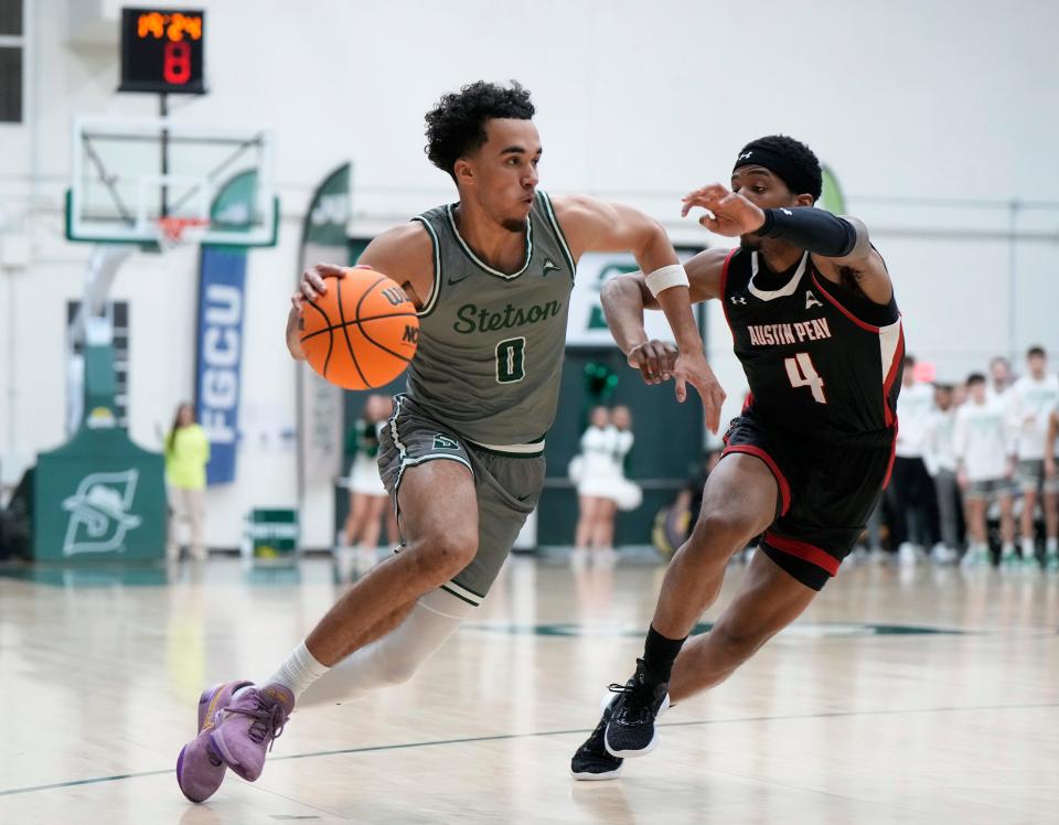 Stetson's Alec Oglesby (0) looks to drive around Austin Peay's Ja'Monta Black (4) during the ASUN Championship game at Edmunds Center in DeLand, Sunday, March 10, 2024.