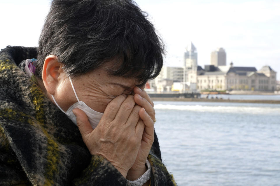 Eiko Kawasaki wipes off the tears as she stands on Dec. 15, 2021, at a port in Niigata, northwest of Japan where she had left for North Korea in 1960 at the age of 17, following the promise of free education and a better life. Kawasaki was among some 93,000 ethnic Korean residents in Japan and their relatives who joined a resettlement program led by North Korea only to find the opposite of what was promised. Most were put to brutal manual labor at mines, in forests and on farms and faced discrimination because of Japan's past colonization of the Korean Peninsula. (AP Photo/Chisato Tanaka)