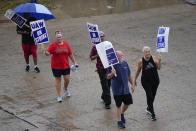 Picketers strike outside of the General Motors assembly plant, Tuesday, Oct. 24, 2023, in Arlington, Texas. The United Auto Workers union is turning up the heat on General Motors as 5,000 workers walked off their jobs at the highly profitable SUV factory. (AP Photo/Julio Cortez)