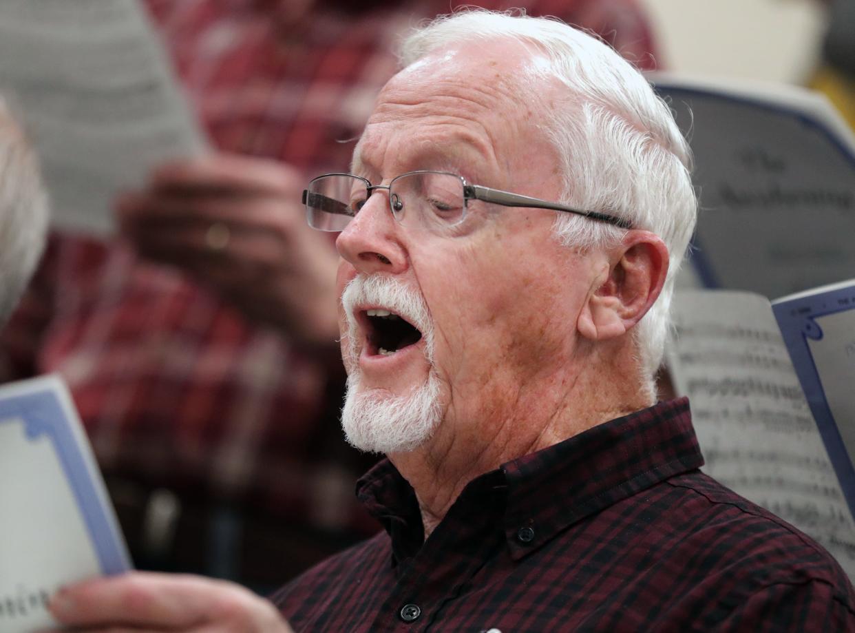 Rick Stark rehearses with the MacDowell Male Chorus, a local arts group celebrating 85 years, at Xavier High 
School earlier this month in Appleton.