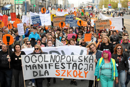 People hold banners during a rally to support a nationwide teachers' strike in central Warsaw, Poland April 24, 2019. Banner reads "Nationwide demonstration for the school". Agencja Gazeta/Jedrzej Nowicki via REUTERS