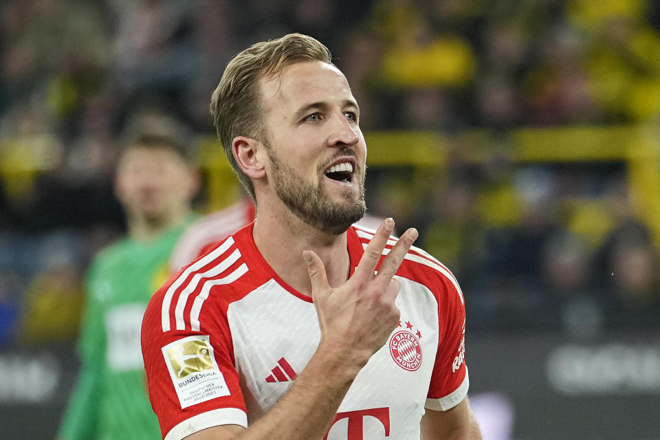 Bayern's Harry Kane celebrates showing fingers after he scored his third goal during the German Bundesliga soccer match between Borussia Dortmund and Bayern Munich in Dortmund, Germany, Saturday, Nov. 4, 2023. (AP Photo/Martin Meissner)