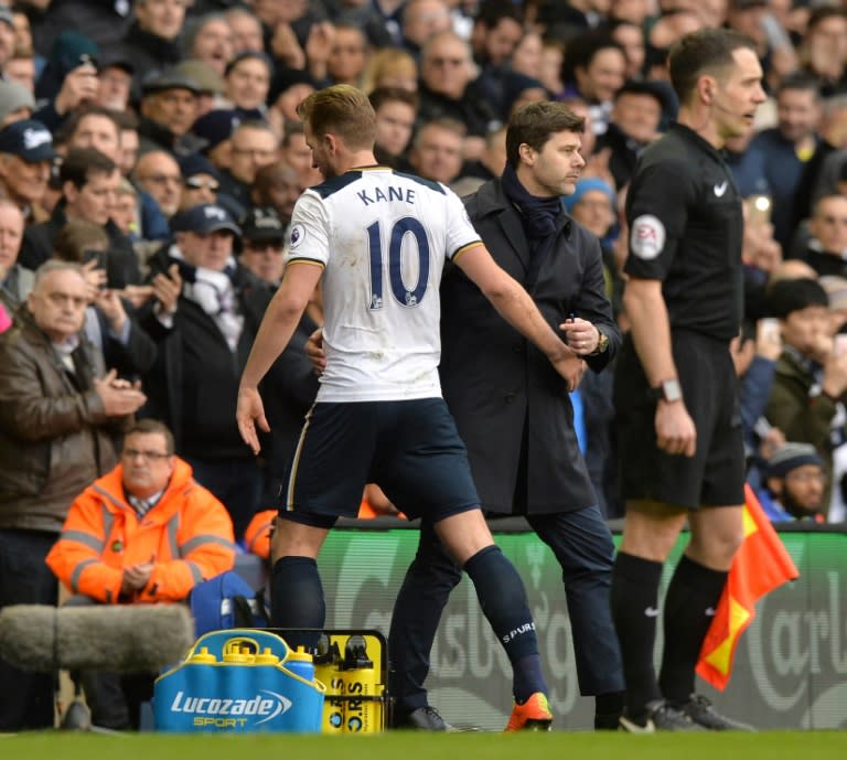 Tottenham Hotspur's Harry Kane (L) is greeted by team manager Mauricio Pochettino as he leaves the pitch substituted during their English Premier League match against Stoke City, at White Hart Lane in London, on February 26, 2017