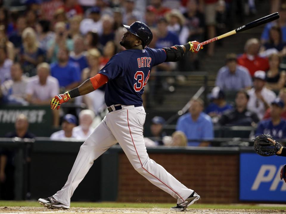 Boston Red Sox's David Ortiz follows through on a fly out to left off a pitch from Texas Rangers' Yu Darvish in the fourth inning of a baseball game, Friday, May 9, 2014, in Arlington, Texas. (AP Photo/Tony Gutierrez)